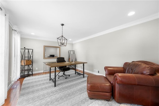 home office with baseboards, crown molding, visible vents, and wood finished floors