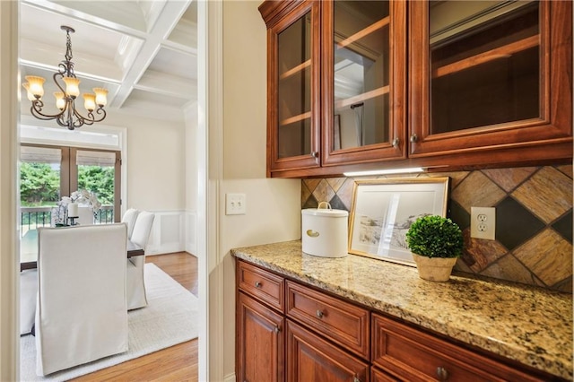 1211 Thornwell Dr, Brookhaven, GA 30319 - kitchen featuring coffered ceiling, a chandelier, light stone countertops, beamed ceiling, and pendant lighting