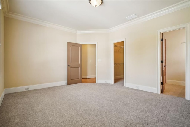 1211 Thornwell Dr, Brookhaven, GA 30319 - unfurnished bedroom featuring crown molding, carpet flooring, a spacious closet, a closet, and baseboards