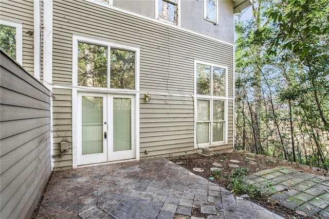 property entrance featuring a patio area and french doors