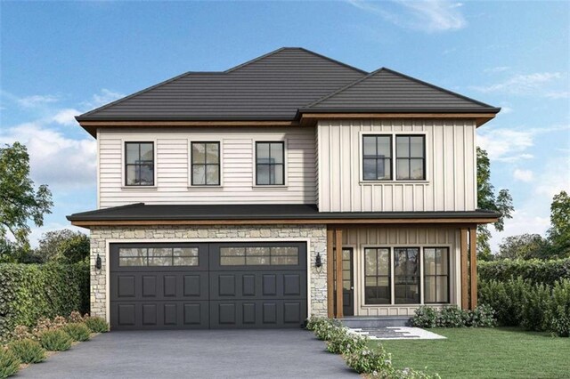 view of front of home with a front yard and a garage