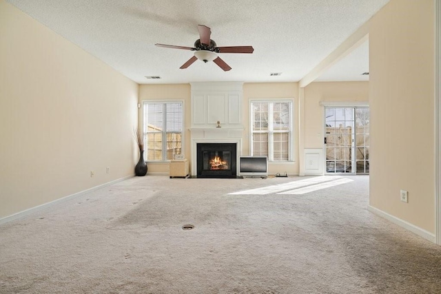 unfurnished living room with a textured ceiling, light colored carpet, a large fireplace, and beamed ceiling