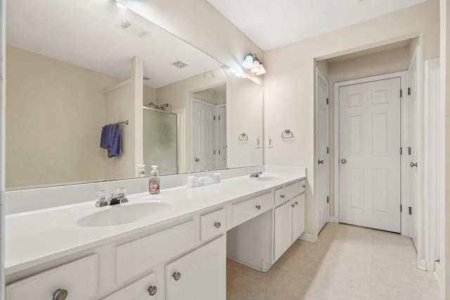 bathroom featuring vanity and a shower with shower door