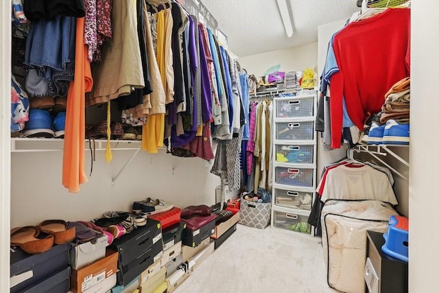 walk in closet featuring carpet flooring