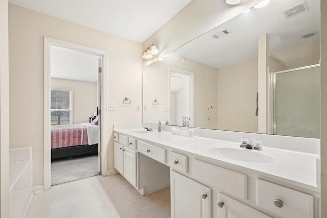 bathroom with walk in shower and vanity