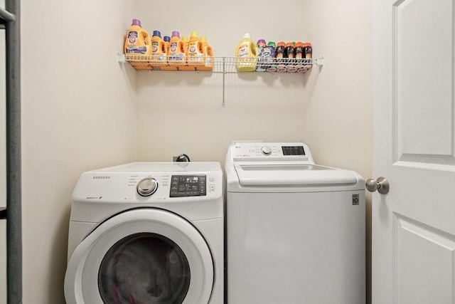 laundry room featuring washing machine and clothes dryer