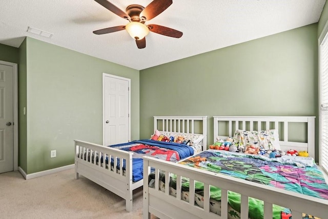 bedroom featuring light colored carpet and ceiling fan