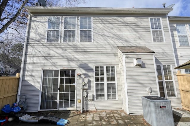 back of house with a deck and central air condition unit