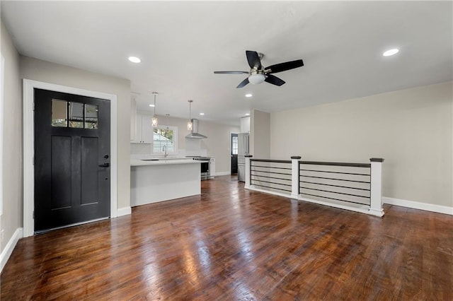 interior space featuring dark wood-style floors, ceiling fan, baseboards, and recessed lighting