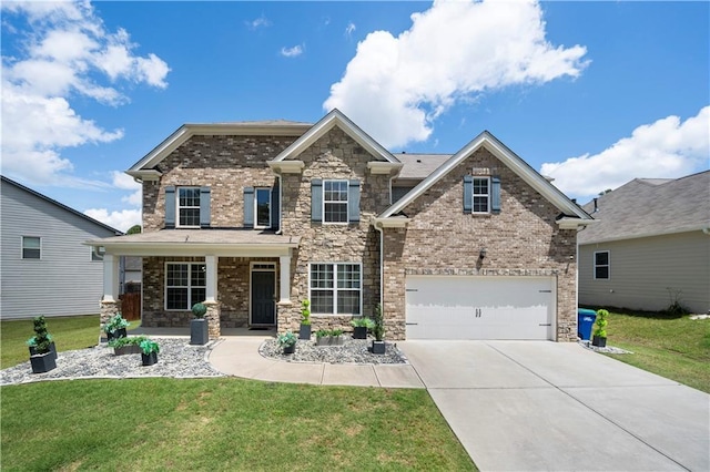 craftsman-style home featuring driveway, a front lawn, stone siding, a garage, and brick siding