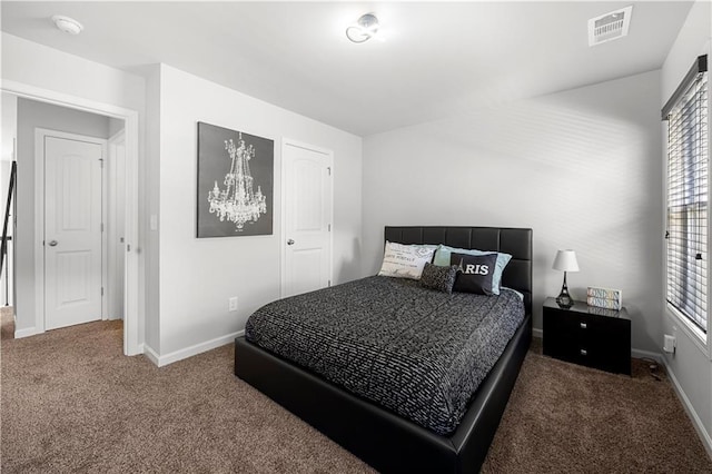 bedroom with carpet, multiple windows, and baseboards