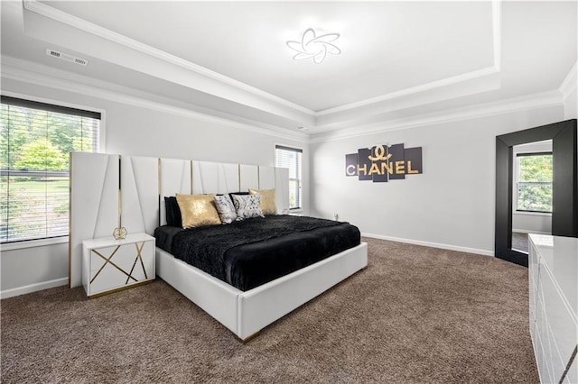 bedroom featuring a raised ceiling, carpet flooring, ornamental molding, and baseboards