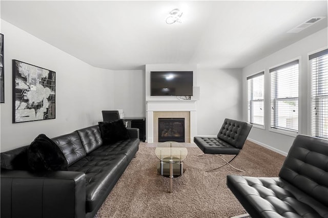 carpeted living room with baseboards and a fireplace