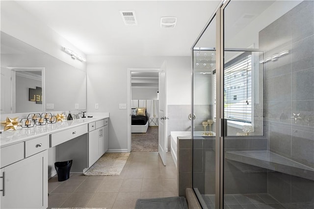 bathroom with a stall shower, double vanity, tile patterned flooring, and ensuite bathroom