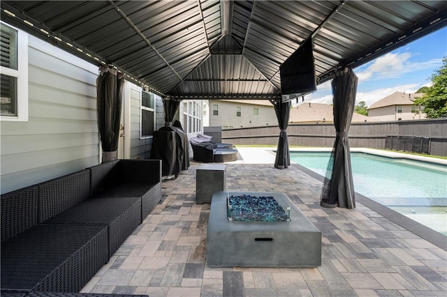 view of swimming pool with a patio, fence, a gazebo, and an outdoor fire pit