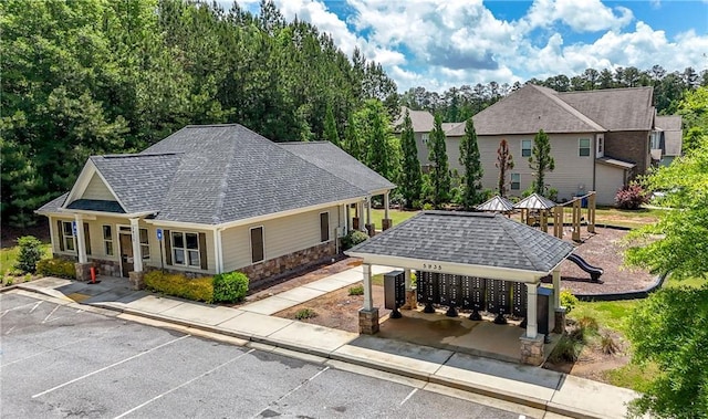 surrounding community with mail area and uncovered parking