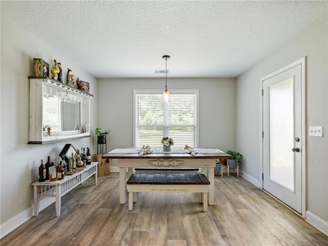 132 Mcmillian Ct, Winder, GA 30680 - dining area featuring wood finished floors, baseboards, and a textured ceiling