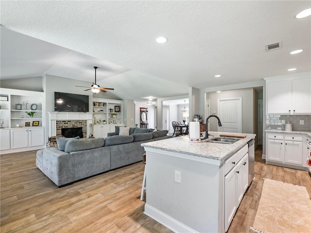 132 Mcmillian Ct, Winder, GA 30680 - kitchen with a sink, dishwasher, vaulted ceiling, a ceiling fan, and light wood-style floors