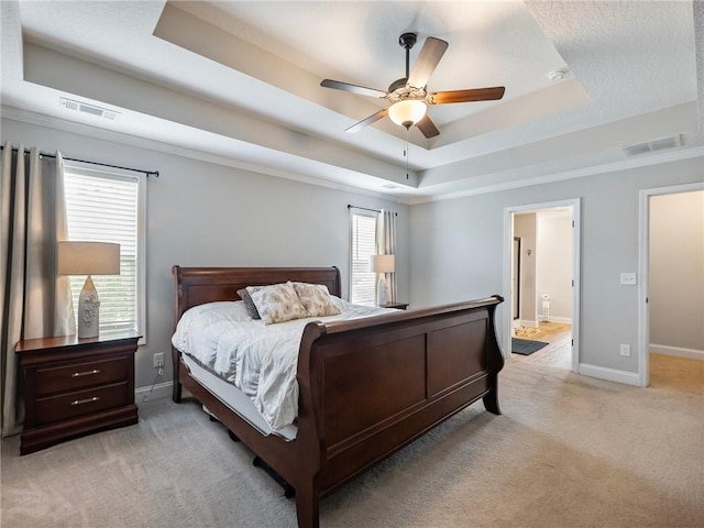 132 Mcmillian Ct, Winder, GA 30680 - bedroom with a raised ceiling, light carpet, baseboards, a ceiling fan, and connected bathroom
