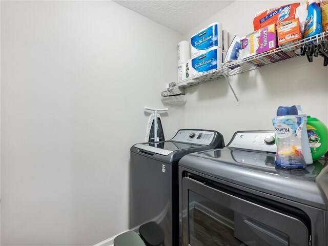 132 Mcmillian Ct, Winder, GA 30680 - laundry room featuring washing machine and clothes dryer and a textured ceiling