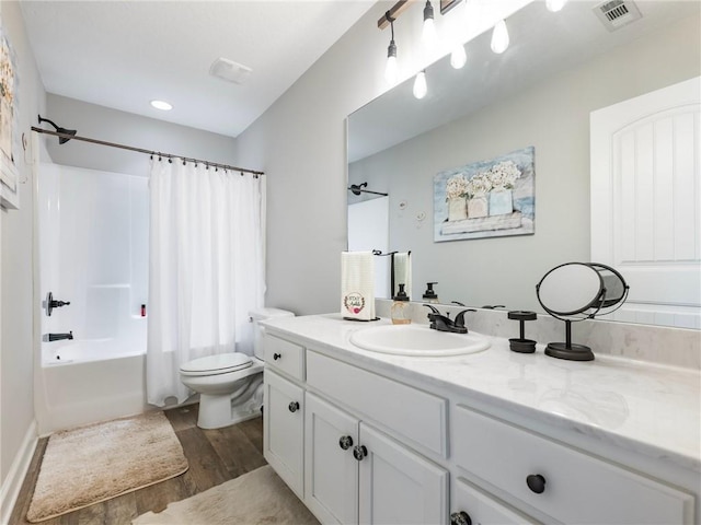 132 Mcmillian Ct, Winder, GA 30680 - bathroom with wood finished floors, vanity, toilet, and shower / bath combo with shower curtain