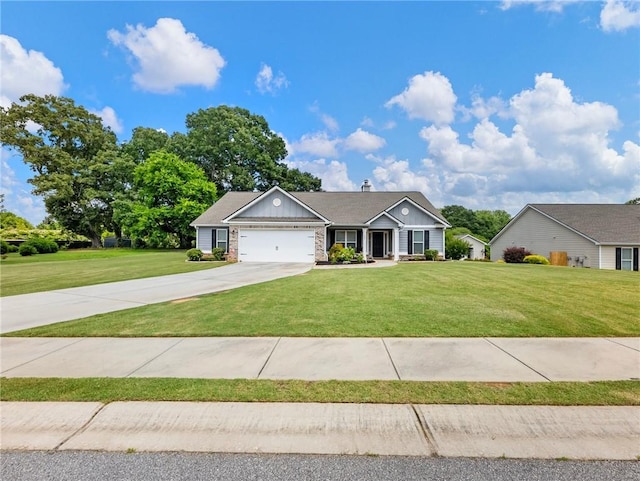 132 Mcmillian Ct, Winder, GA 30680 - view of front of home featuring a front lawn, a garage, concrete driveway, and board and batten siding
