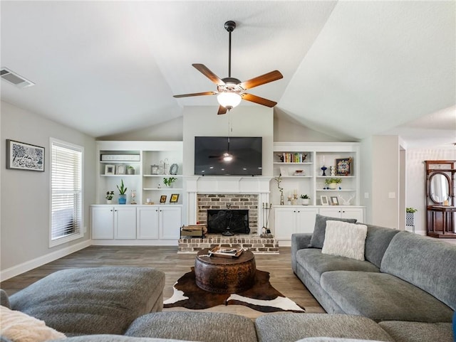 132 Mcmillian Ct, Winder, GA 30680 - living area with lofted ceiling, a ceiling fan, wood finished floors, a fireplace, and baseboards