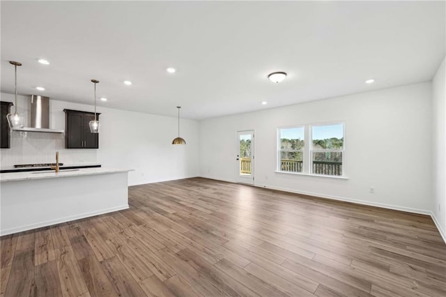 unfurnished living room featuring dark hardwood / wood-style floors and sink