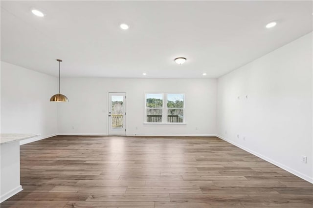 unfurnished living room featuring hardwood / wood-style flooring