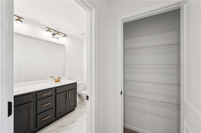 bathroom featuring vanity and toilet