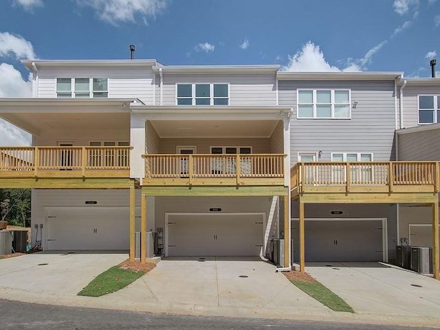 view of front of property with a balcony, a garage, and central air condition unit