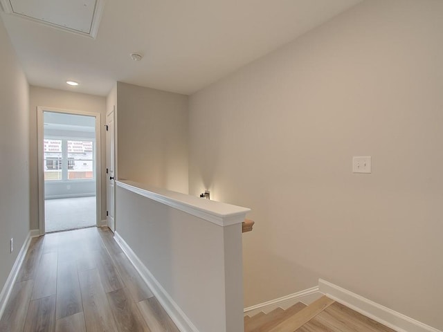 hallway with light hardwood / wood-style flooring