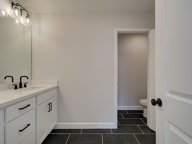 bathroom featuring tile patterned floors, vanity, and toilet