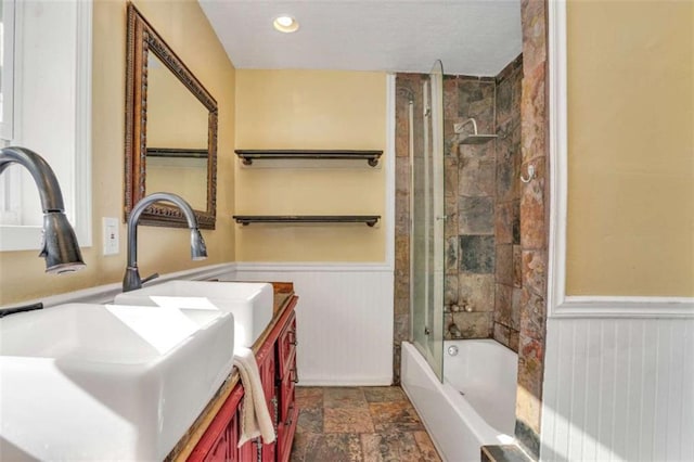 bathroom featuring bath / shower combo with glass door and vanity