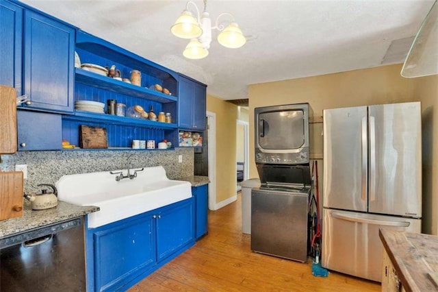 kitchen featuring butcher block countertops, stainless steel refrigerator, black dishwasher, and blue cabinets