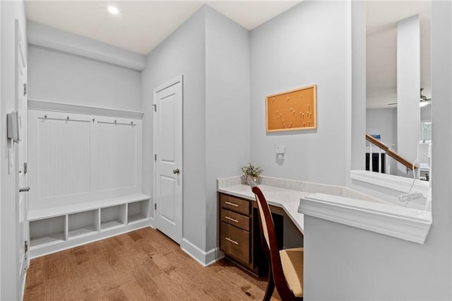 office space featuring built in study area, light wood-style floors, recessed lighting, and baseboards