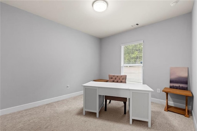 office space with baseboards and light colored carpet