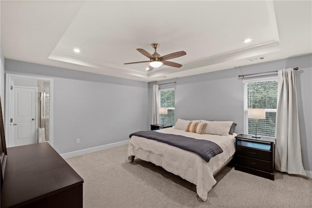 bedroom with a tray ceiling, light colored carpet, baseboards, recessed lighting, and a ceiling fan