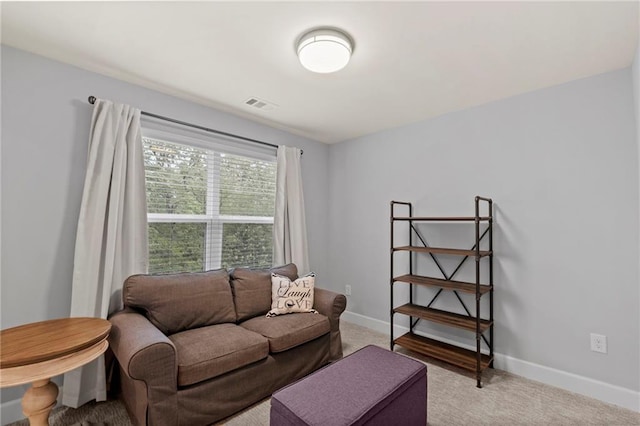 living room with light carpet and baseboards
