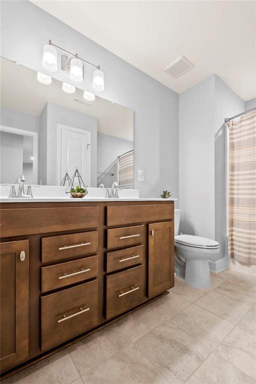 full bathroom featuring toilet, double vanity, tile patterned floors, and curtained shower