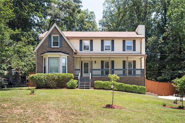 view of front of home with a porch and a front lawn