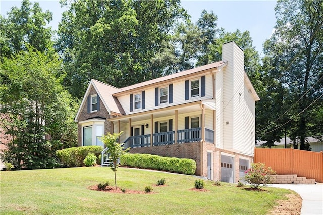 view of front of house featuring a porch, a front lawn, and a garage