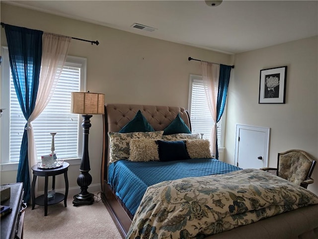 bedroom with multiple windows and carpet flooring