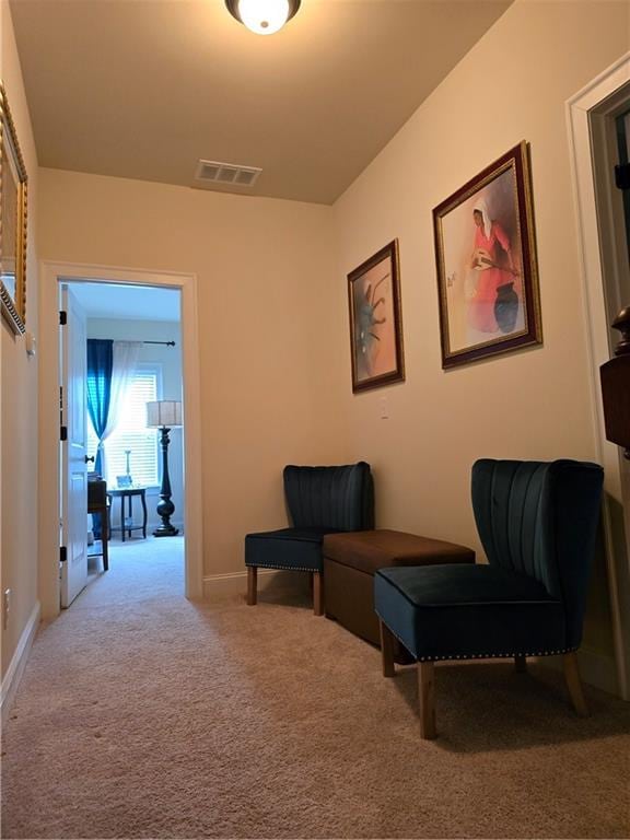 sitting room featuring carpet flooring