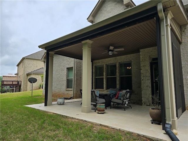 rear view of property featuring a patio area, a yard, and ceiling fan