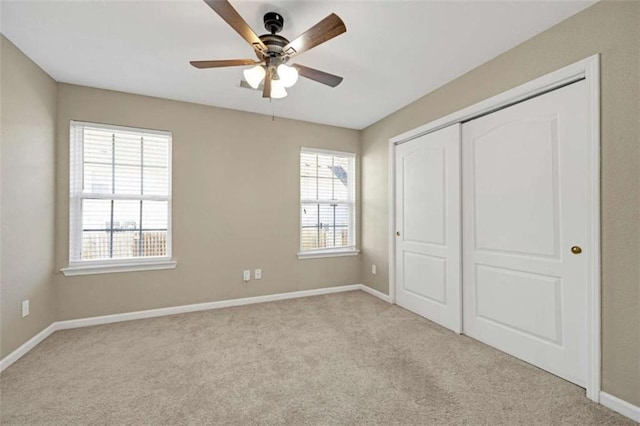 unfurnished bedroom featuring a closet, light carpet, and ceiling fan