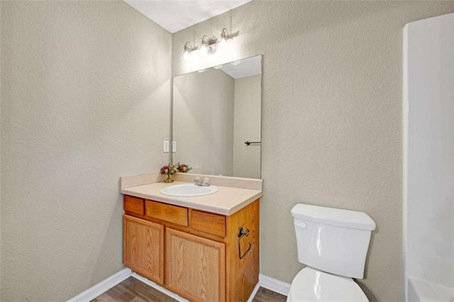 bathroom featuring hardwood / wood-style floors, vanity, and toilet