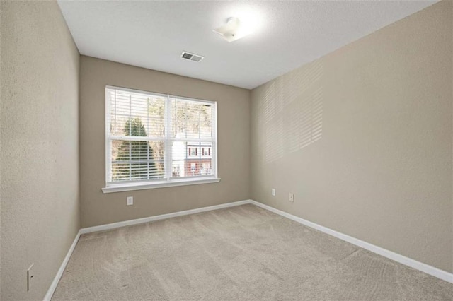 empty room featuring light colored carpet