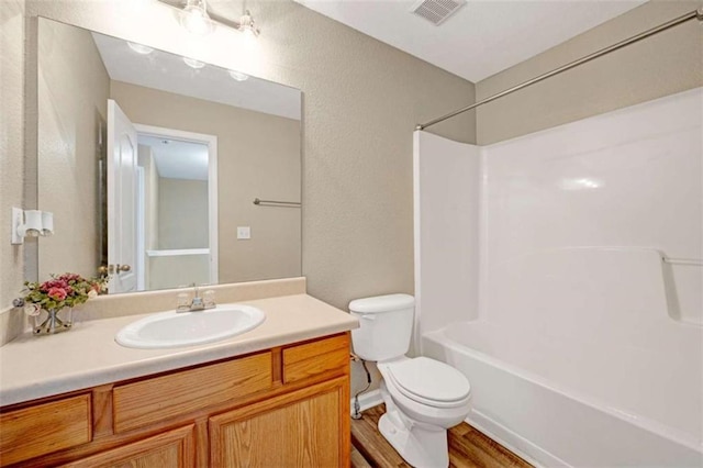 full bathroom featuring toilet, vanity, shower / tub combination, and hardwood / wood-style flooring