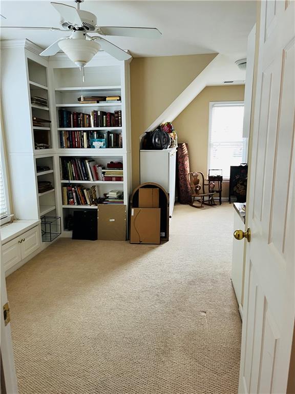 interior space with ceiling fan and carpet floors